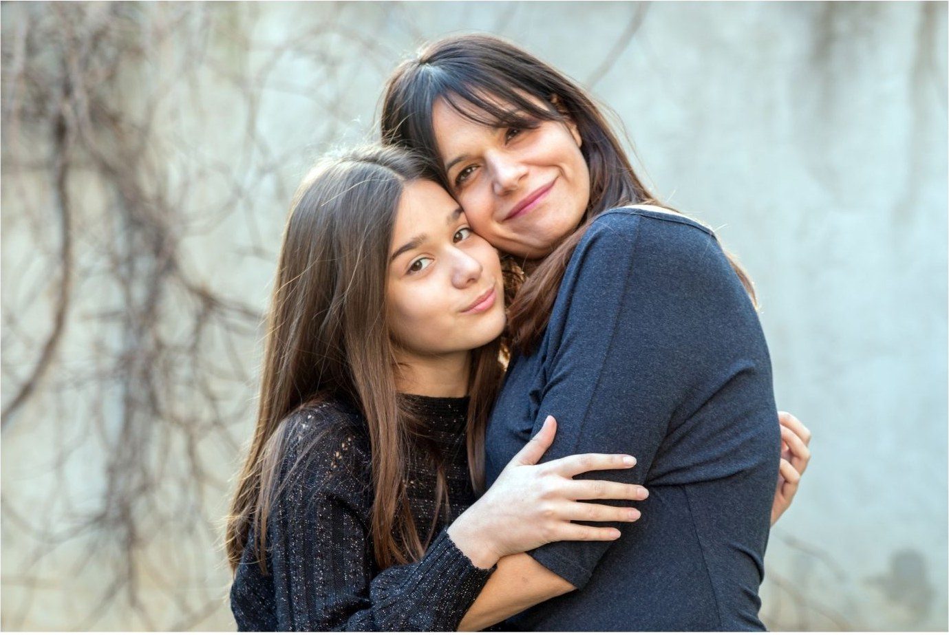 A mother and daughter holding each other
